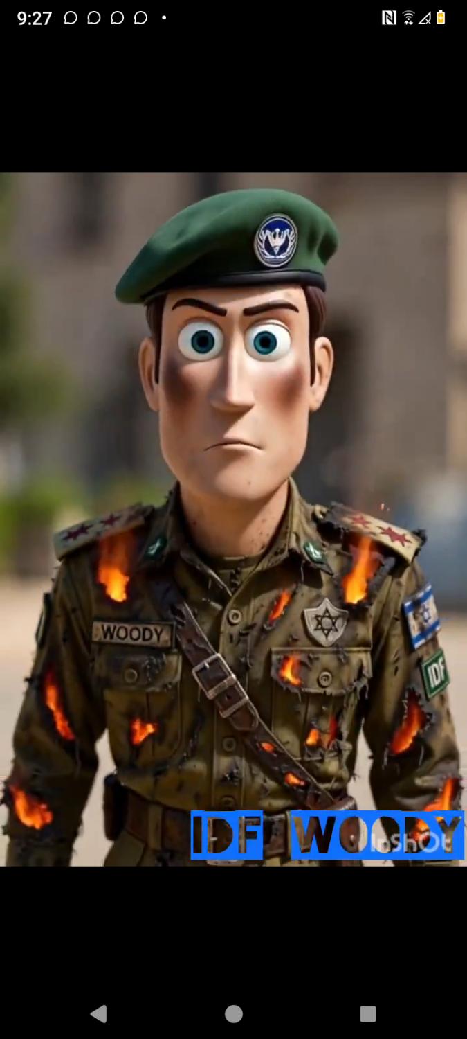 Incoming satire still: press-secretary mask in burning IDF kit. Not a studio toy. A mask on a spokesman.